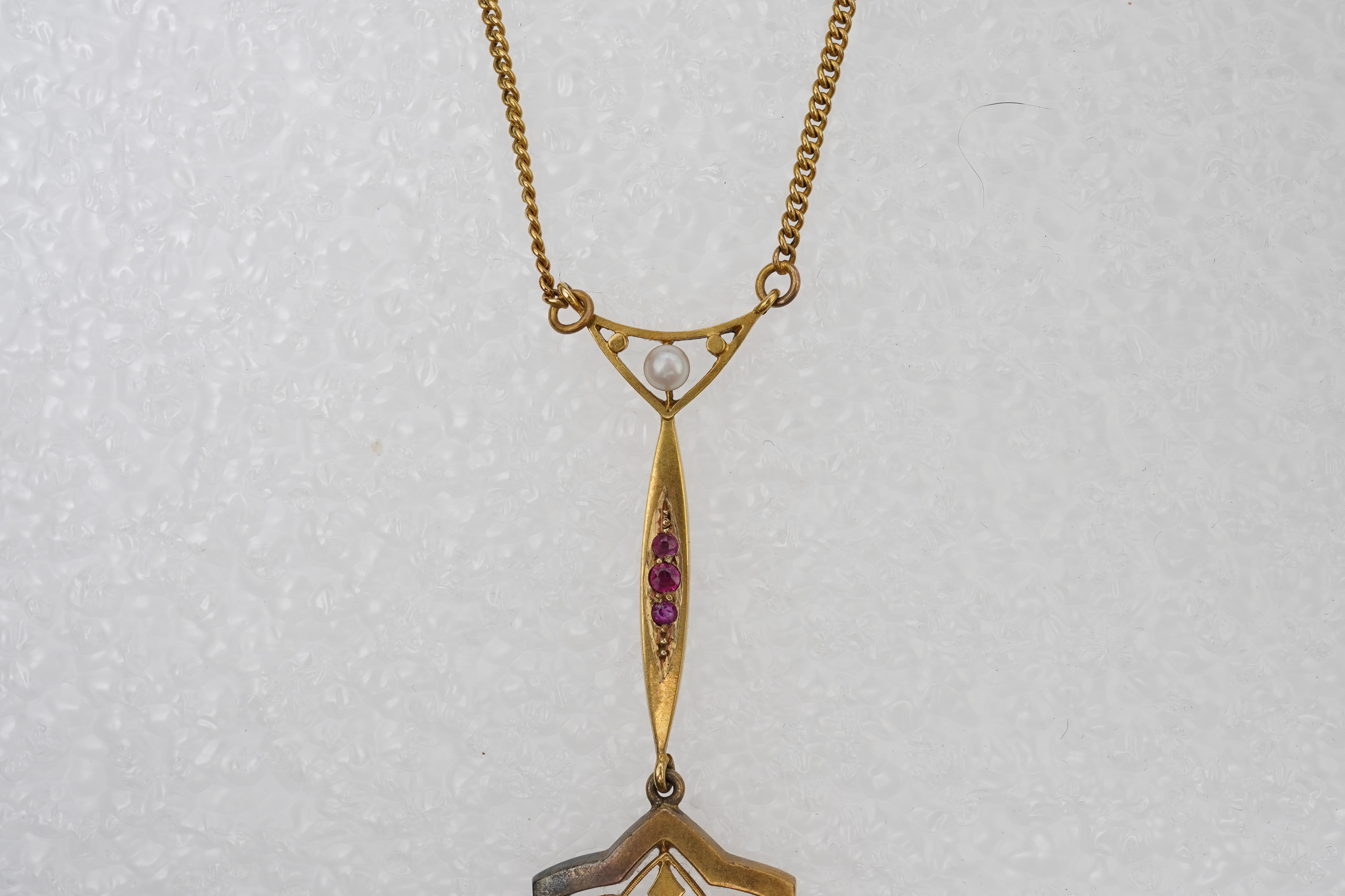 A gold, ruby and seed pearl pendant necklace, early 20th century
